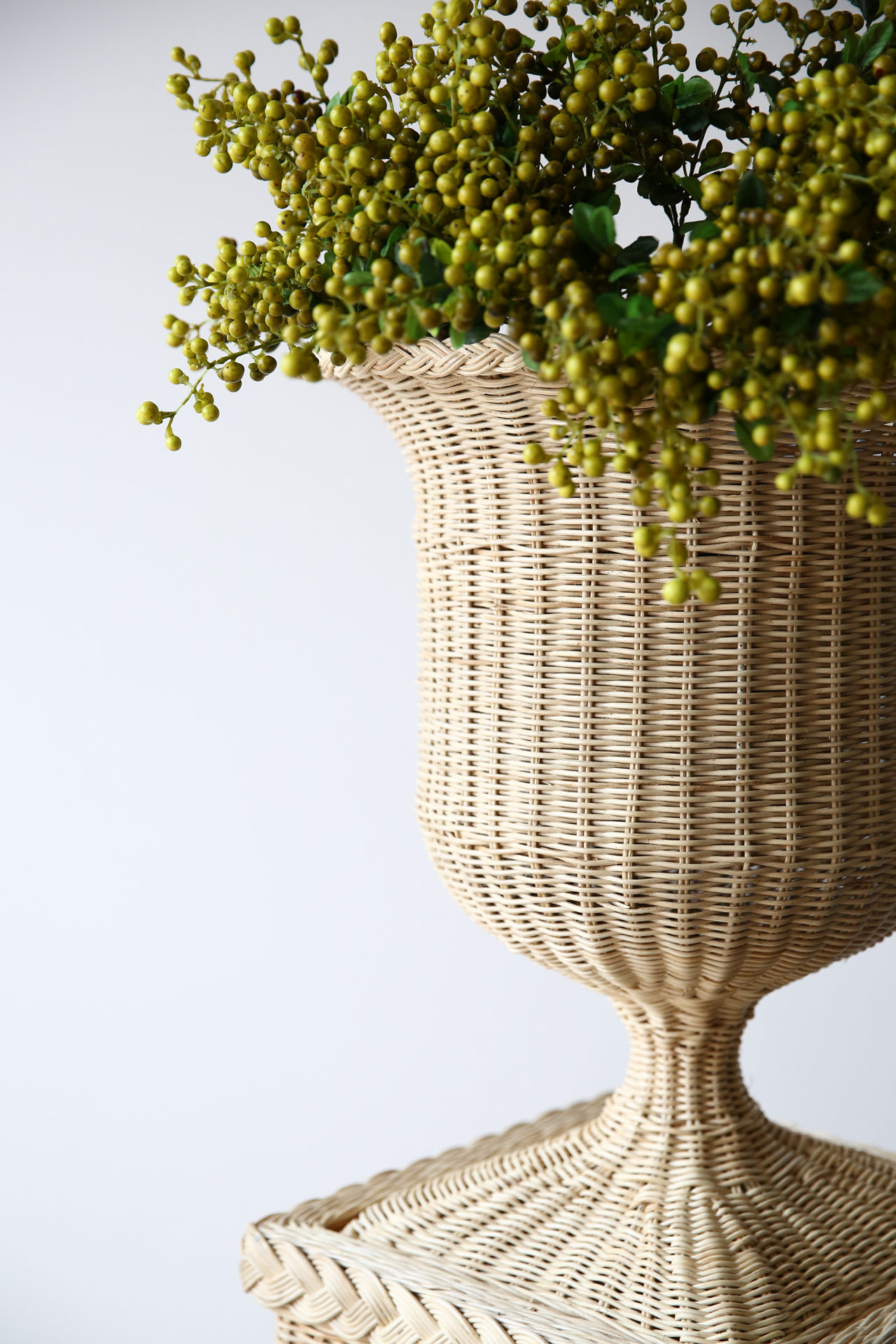 Handwoven natural rattan pedestal and vase set, ideal for indoor or covered outdoor display