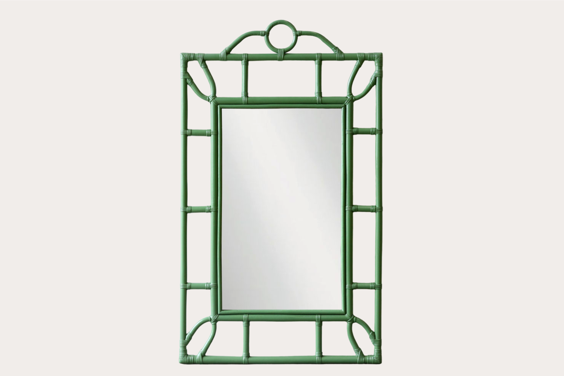 Tropical-style rattan mirror with green bamboo-look frame and circular top detail