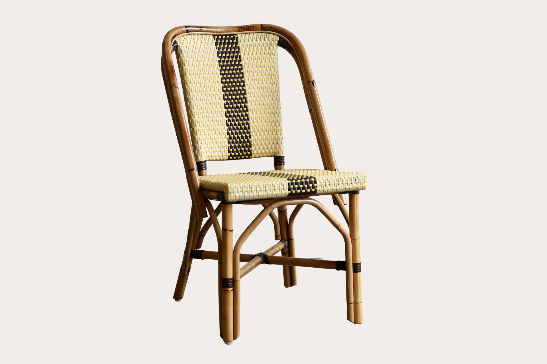 Wicker chair with a striped backrest on a light background