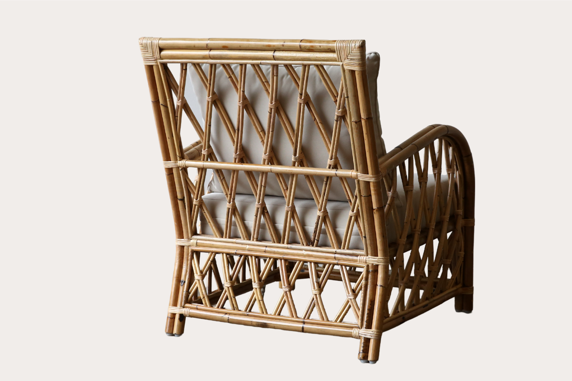 Fort Mill armchair in natural rattan with geometric frame and upholstered seat and back cushions