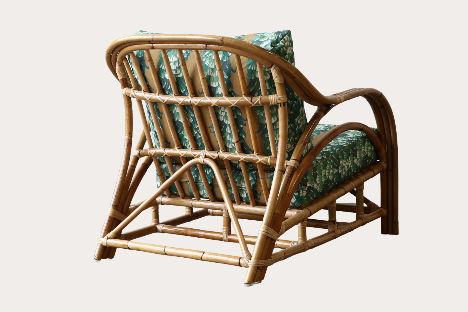 Natural rattan armchair suitable for relaxed indoor seating in residential or hospitality settings