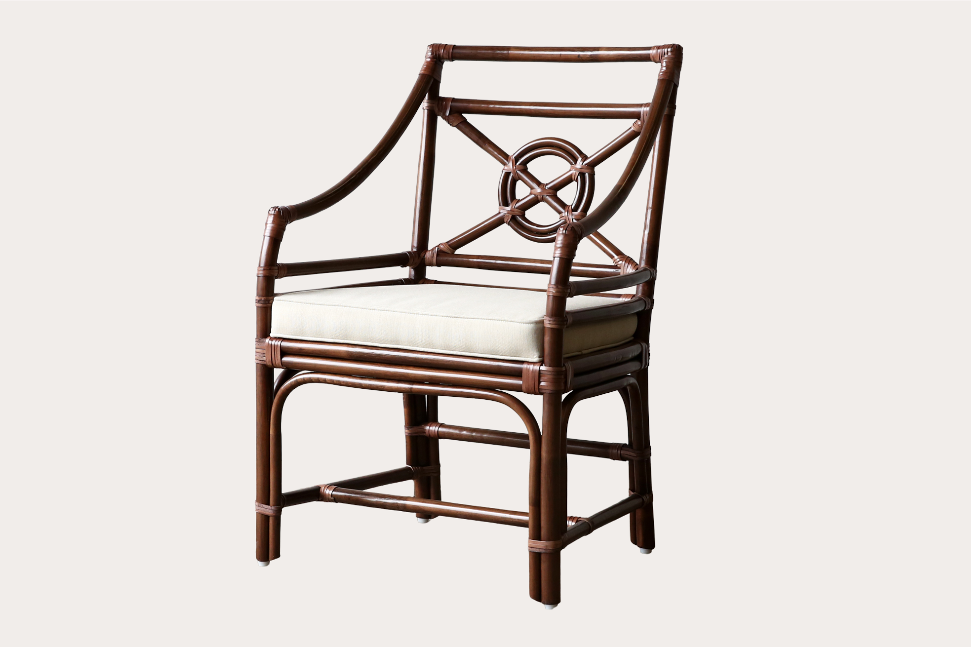 Handcrafted rattan dining chair in brown wash finish with circular lattice back and padded seat