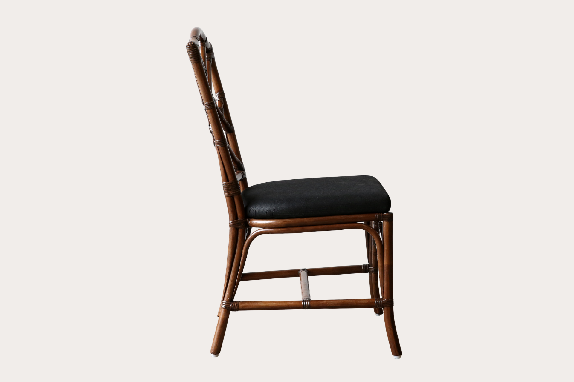 carved chippendale dining chair made with rattan and wood. Finished in brown washed wicker.