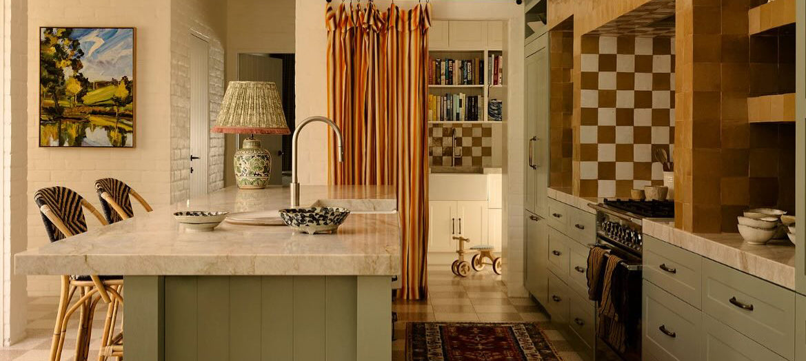 Handwoven rattan bar stools with arched backs in a rustic kitchen interior