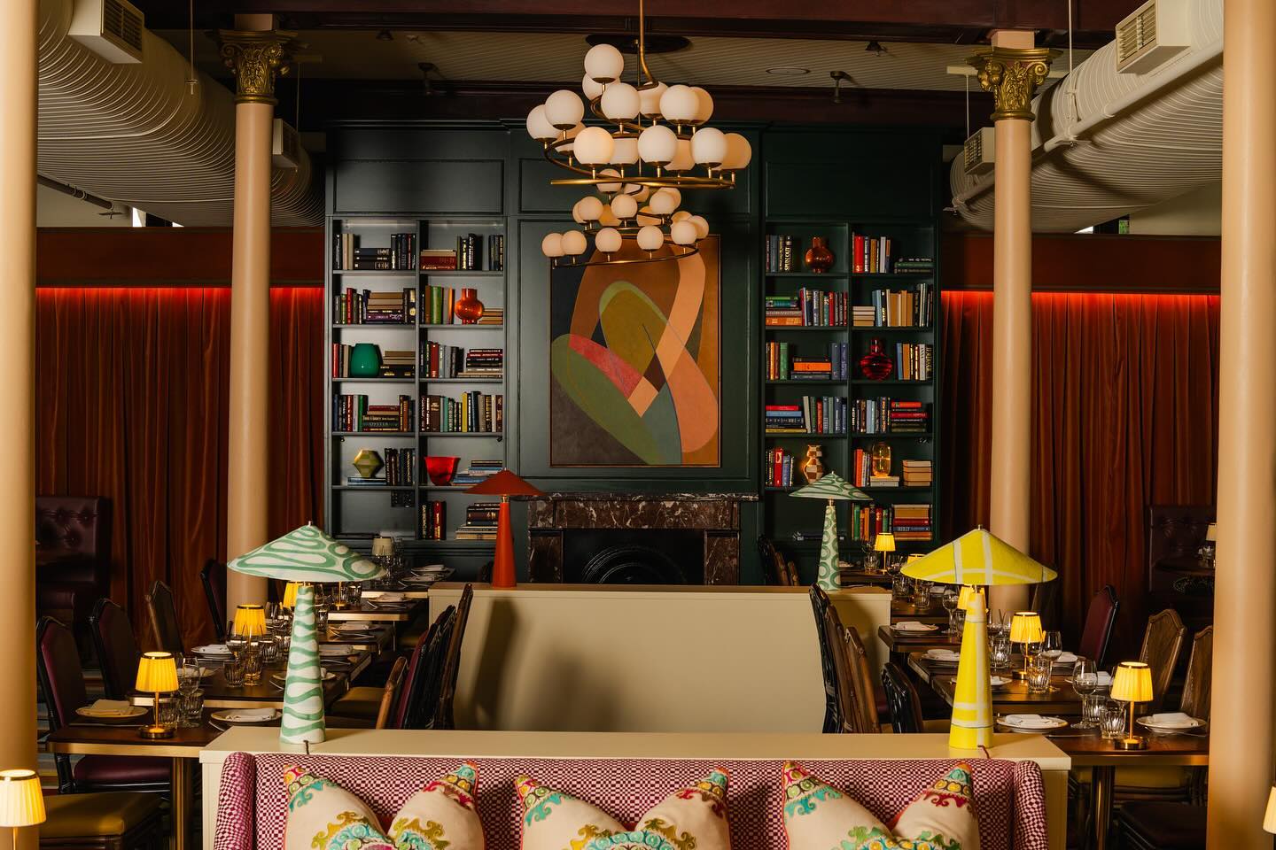 Stylish restaurant interior with layered lighting, artful decor, and rattan-inspired seating, ideal for commercial hospitality venues