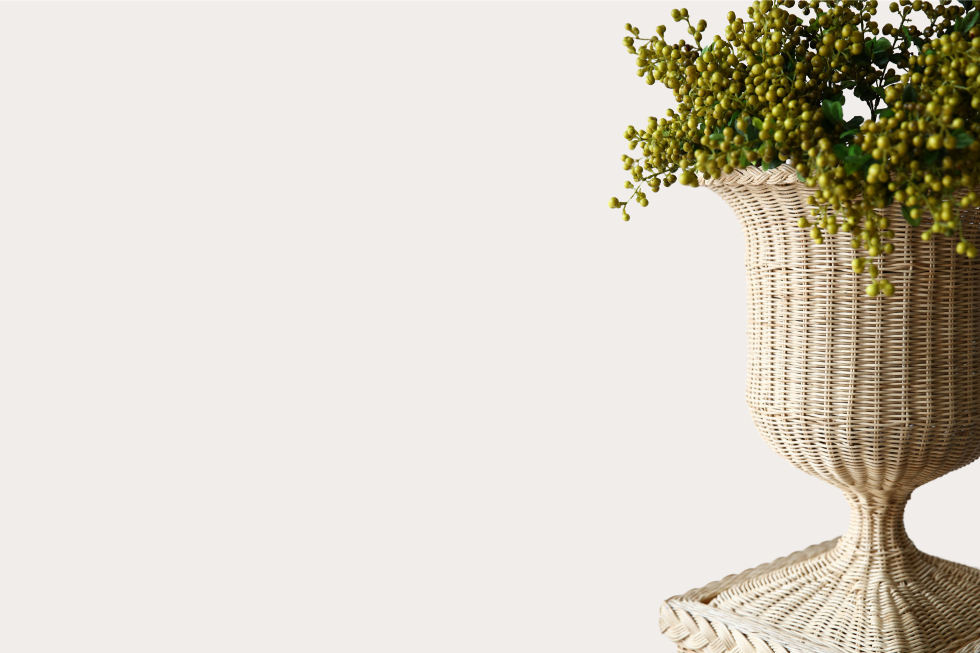 Handwoven natural rattan pedestal and vase set, ideal for indoor or covered outdoor display
