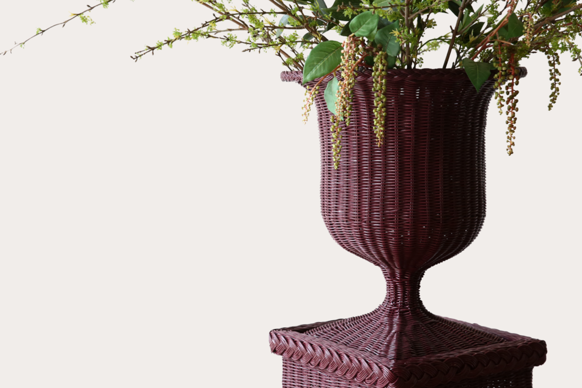 Handwoven natural rattan pedestal and vase set, ideal for indoor or covered outdoor display.