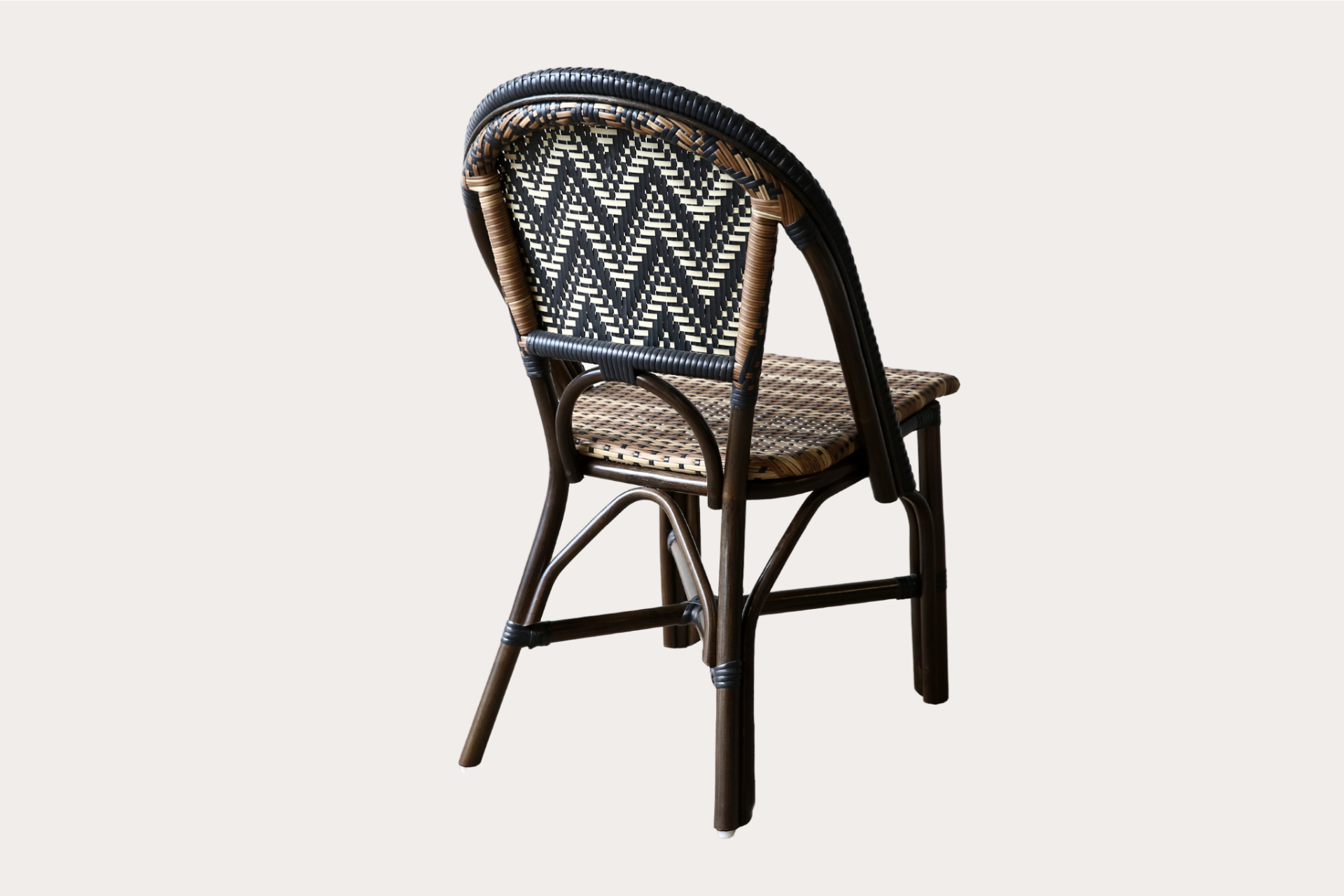 Commercial-grade woven side chair with black and natural chevron pattern, suitable for indoor and outdoor dining