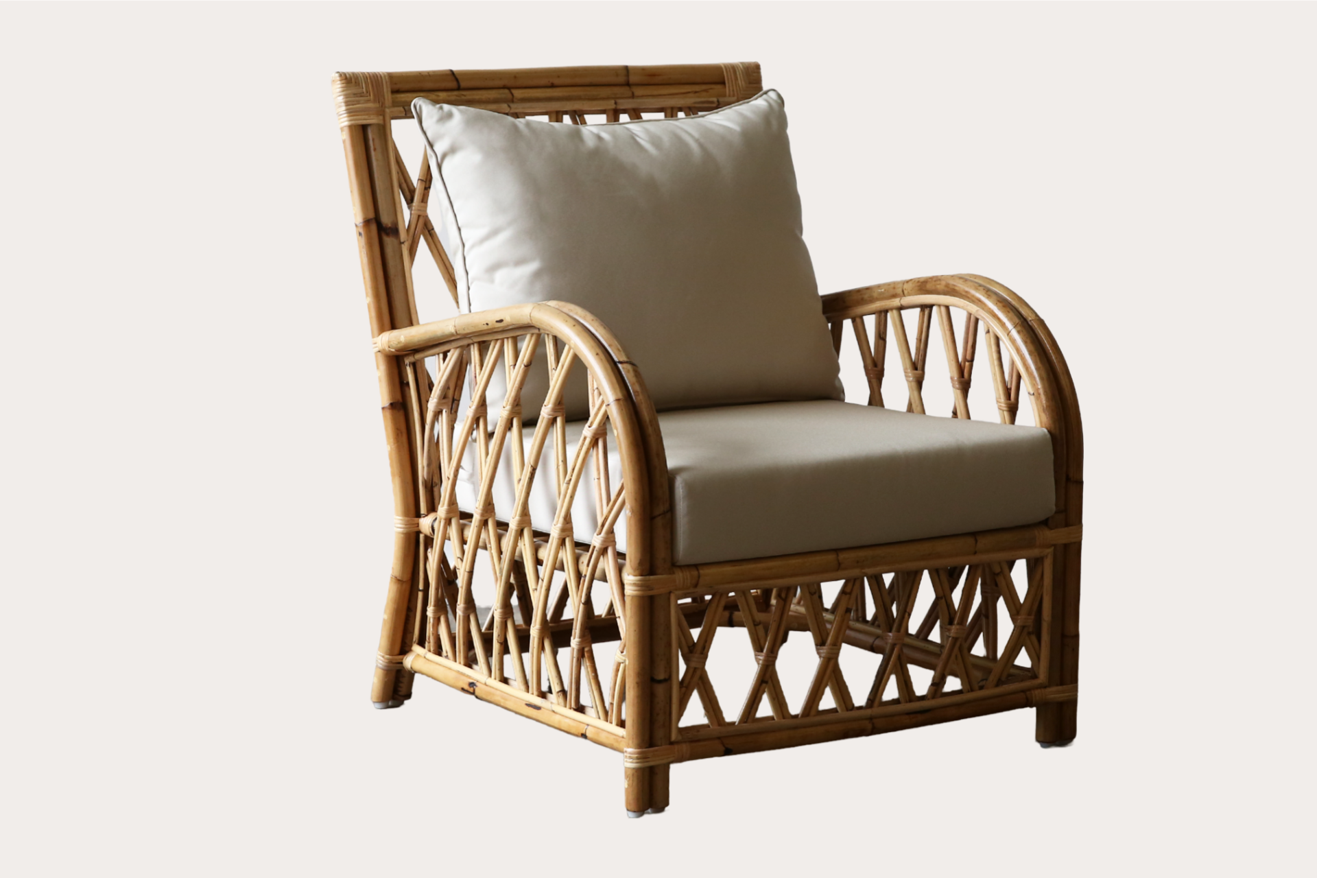 Fortmill armchair in natural rattan with geometric frame and upholstered seat and back cushions