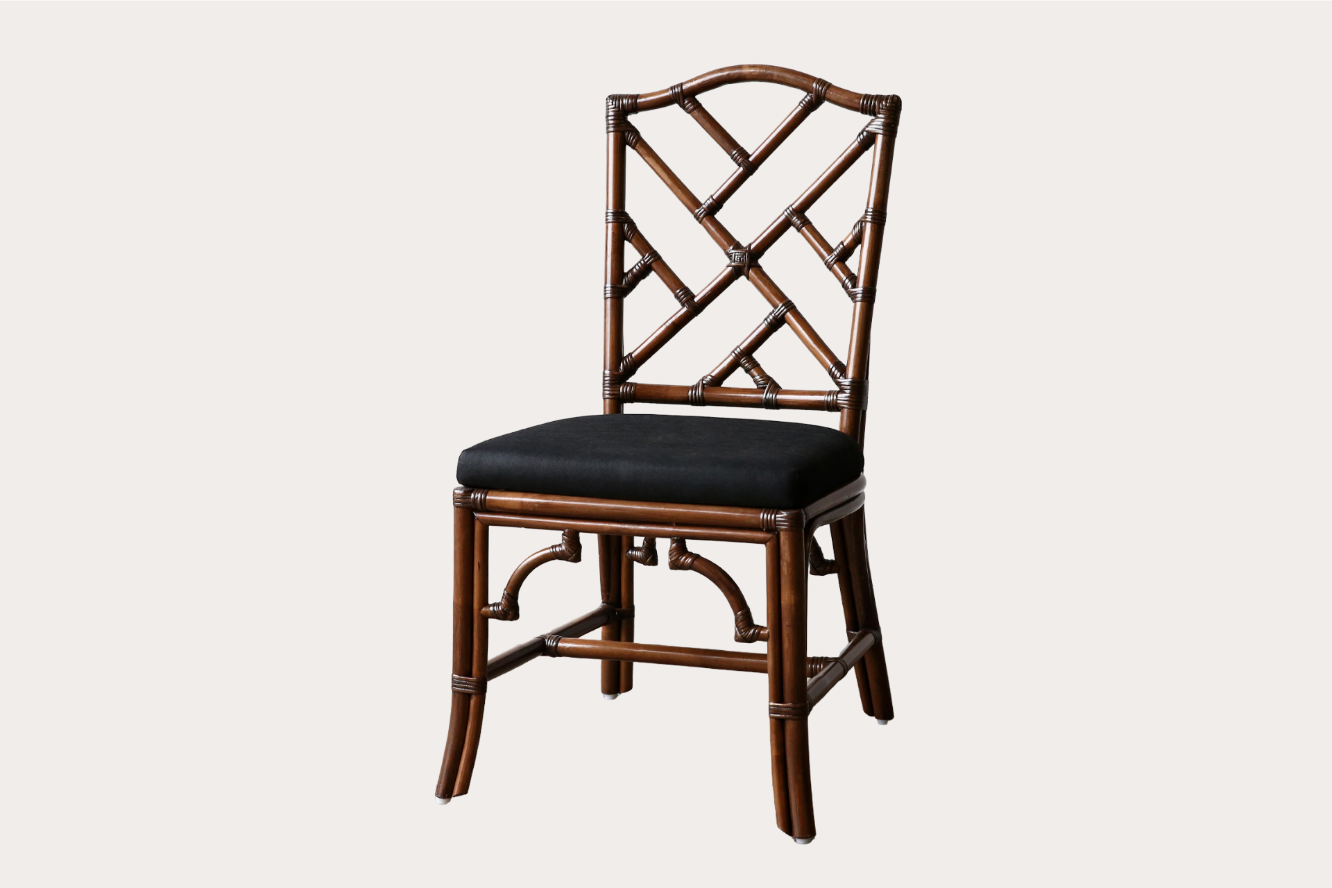 carved rattan dining chair with upholstered seats and brown washed frames in a chippendale style.