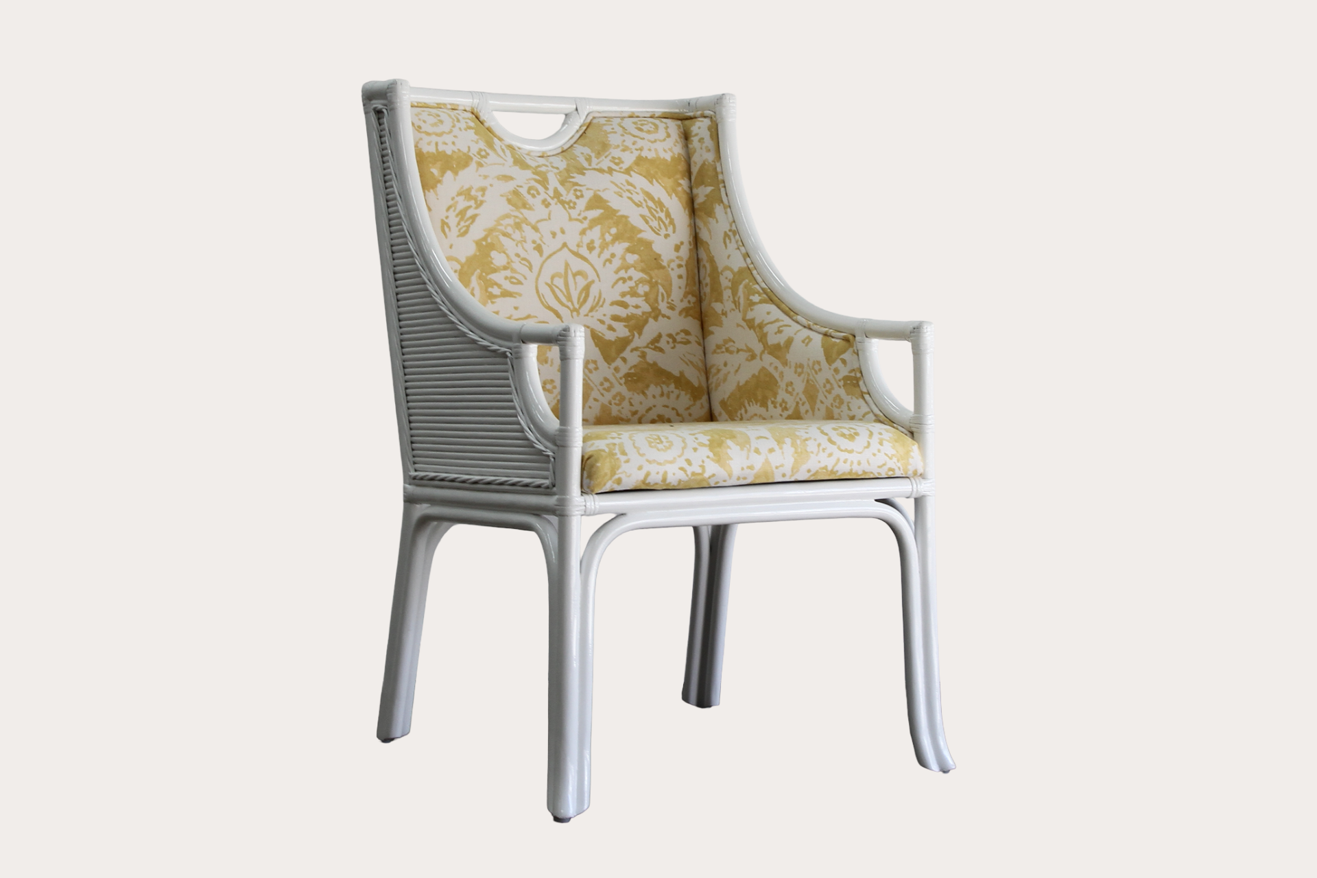 Chair with patterned yellow cushion on a white background