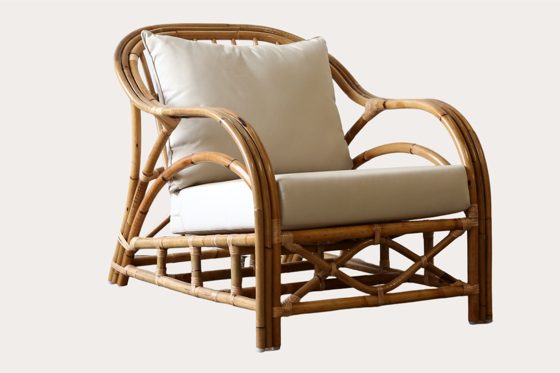 Natural rattan armchair suitable for relaxed indoor seating in residential or hospitality settings