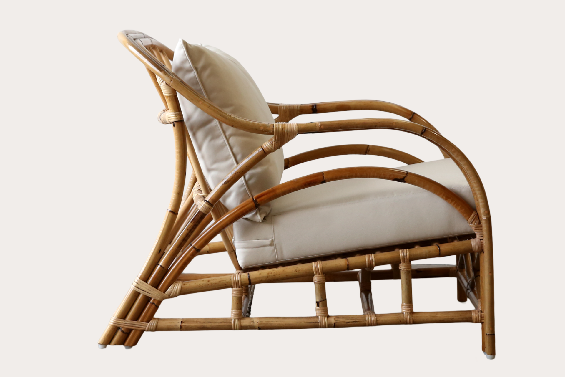 Natural rattan armchair suitable for relaxed indoor seating in residential or hospitality settings