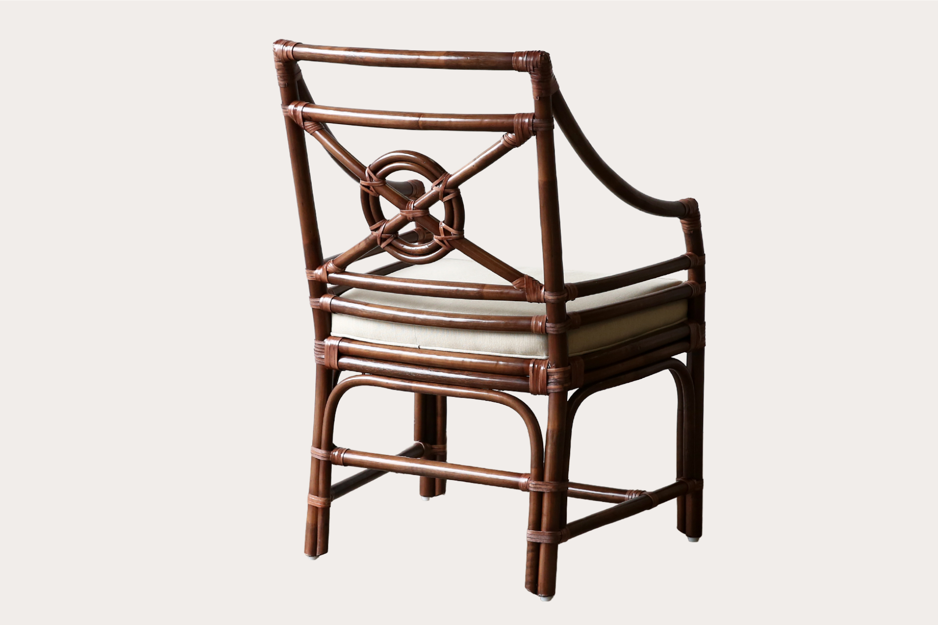 Handcrafted rattan dining chair in brown wash finish with circular lattice back and padded seat