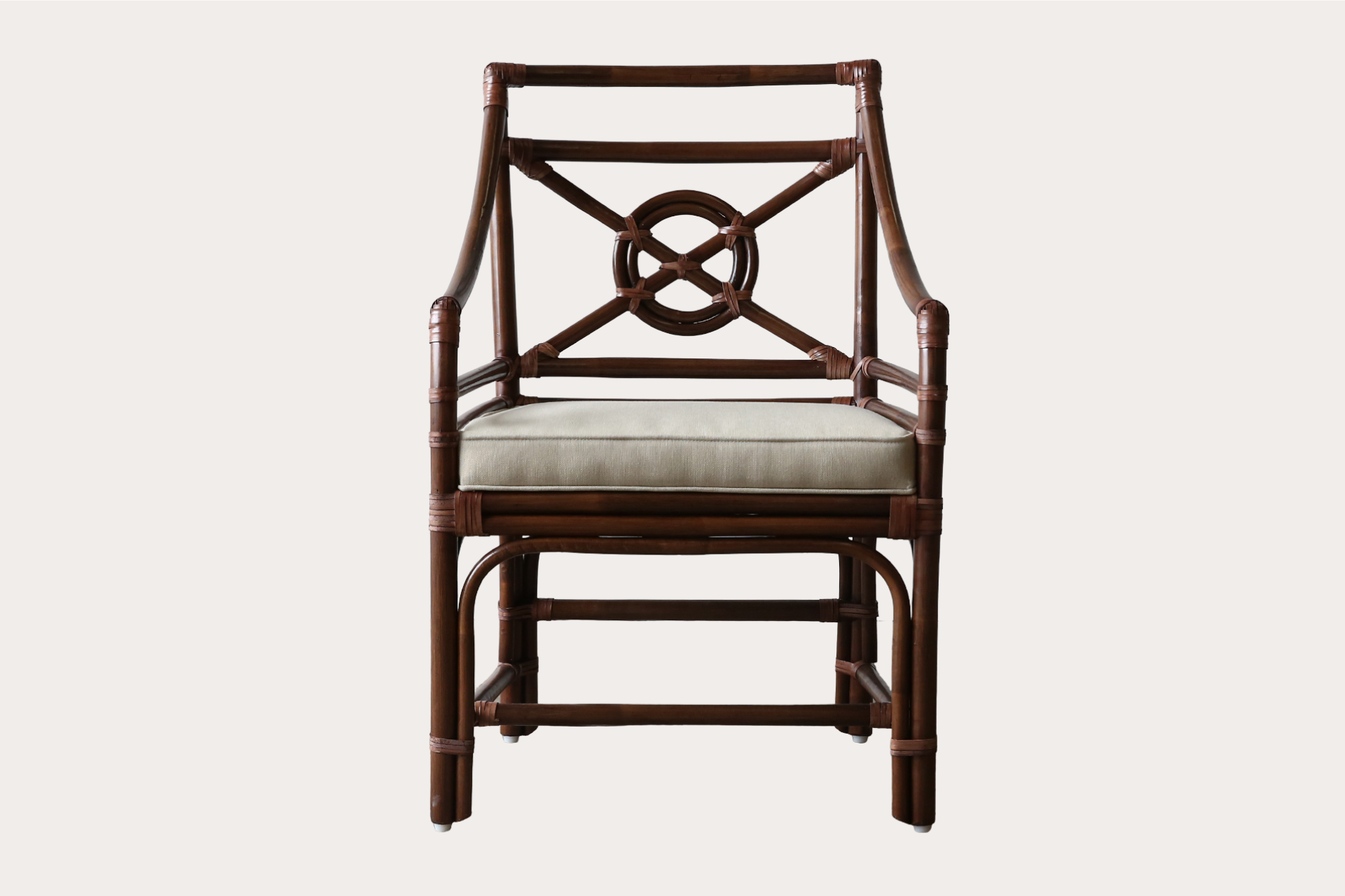 Handcrafted rattan dining chair in brown wash finish with circular lattice back and padded seat