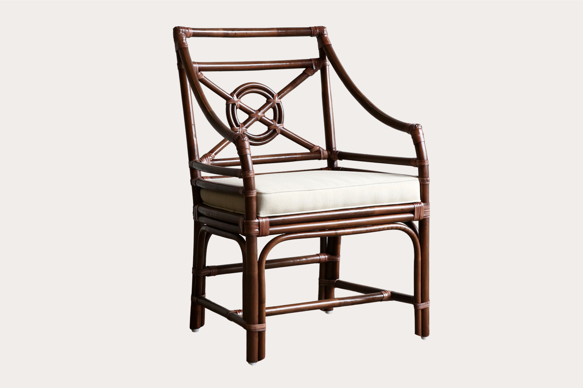 Handcrafted rattan dining chair in brown wash finish with circular lattice back and padded seat