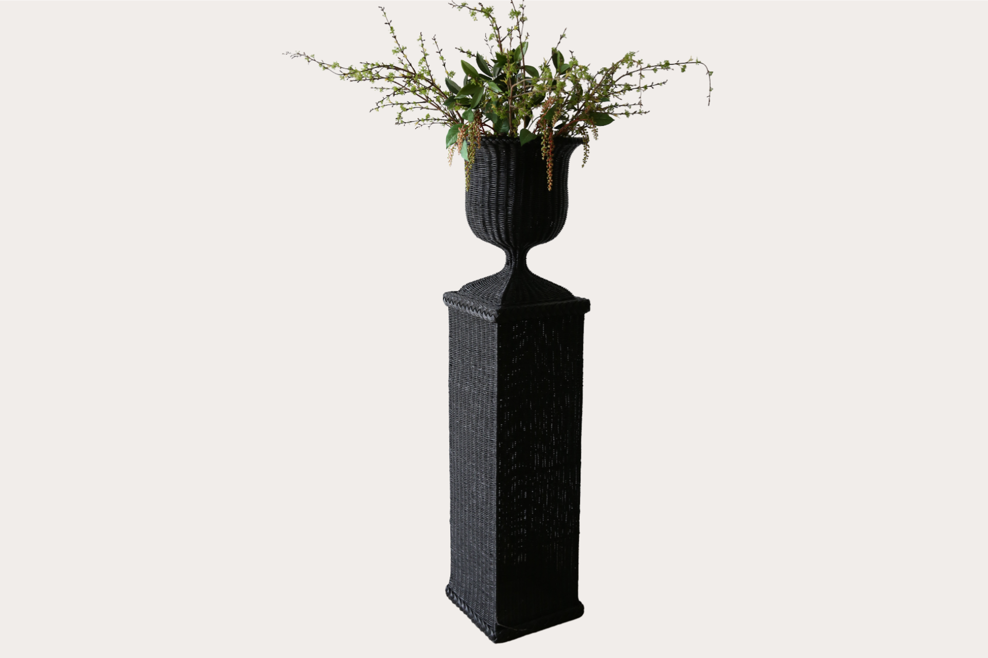 Handwoven natural rattan pedestal and vase set, ideal for indoor or covered outdoor display.