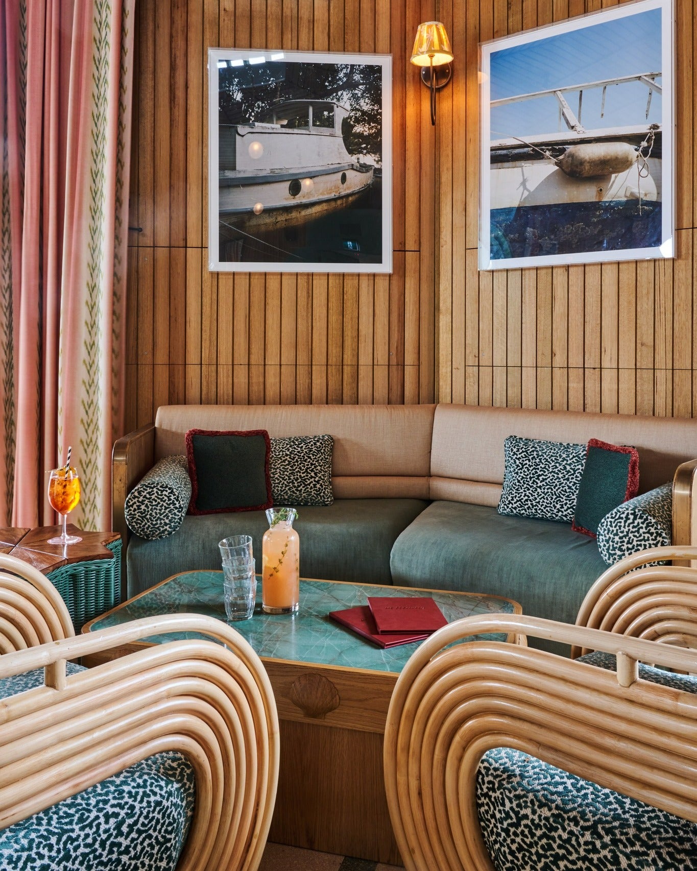 Curved rattan armchairs and upholstered bar stools in a modern hospitality bar interior